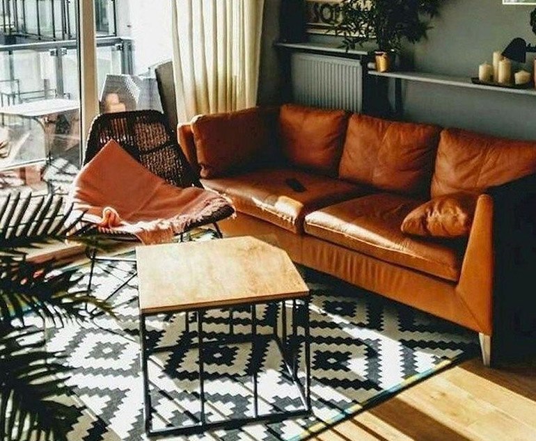 black and white rug with brown couch