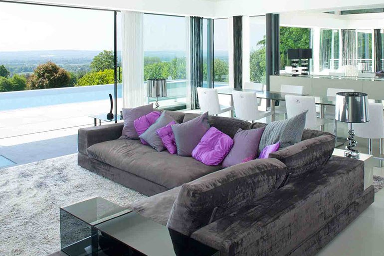 dark grey couch purple pillows